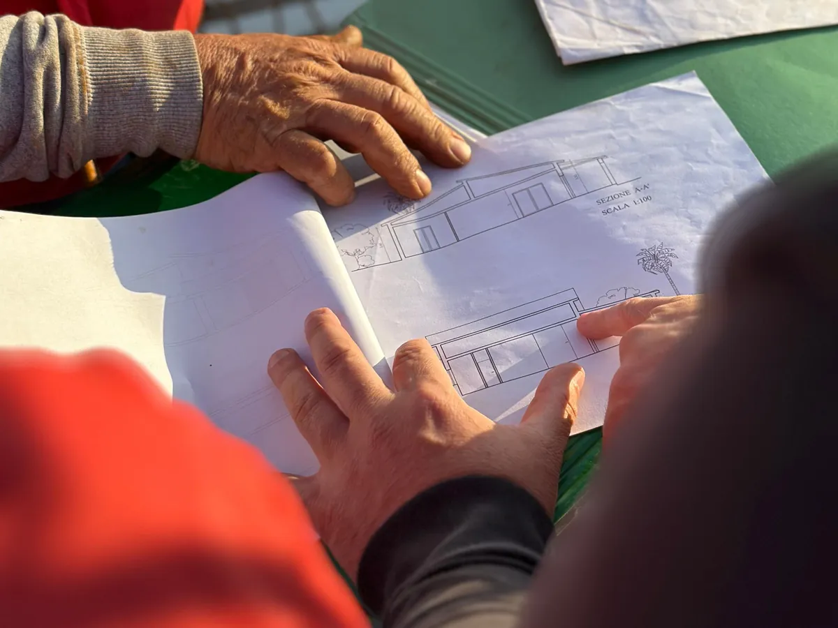 Project team reviewing construction drawings together at a table